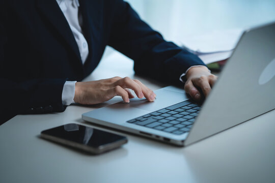 Businessman Working on Laptop at Office Desk While Experiencing Workplace Stress and Mental Pressure During a Busy Workday