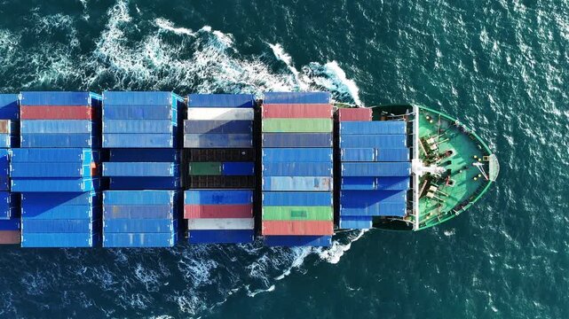 container ship fully loaded with colorful cargo sailing through the deep blue ocean water. Global maritime logistics, international shipping trade, and marine freight transport concept.