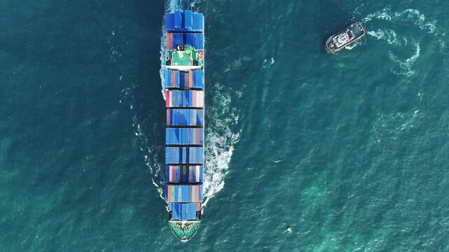 container ship fully loaded with colorful cargo sailing through the deep blue ocean water. Global maritime logistics, international shipping trade, and marine freight transport concept.