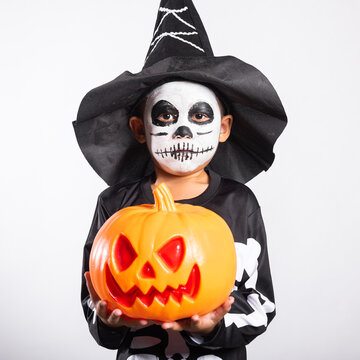 Halloween celebration featuring kid wearing spooky costume holding plastic pumpkin bucket against isolated white background for holiday party event