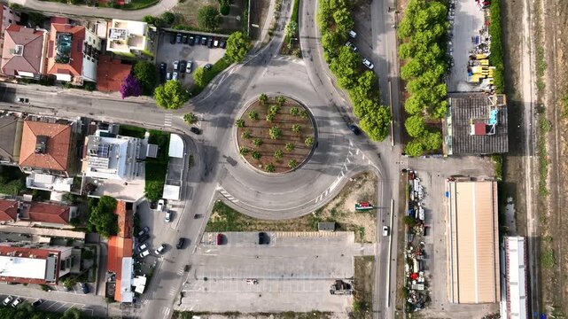 Aerial view of roundabout with palm trees surrounded by urban buildings and roads in San Benedetto del Tronto, Marche, Italy.