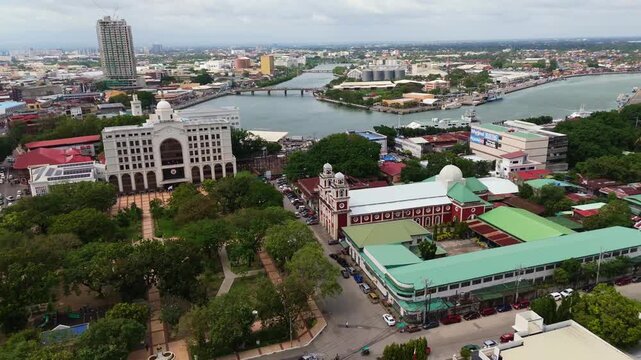 Aerial view of Iloilo City featuring the City Hall, the winding Iloilo River, and historic church architecture in Iloilo City, Western Visayas, Philippines.