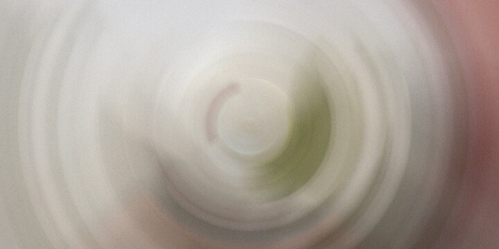 Abstract blurred white and green radial blur background for clean minimalist design and presentations.