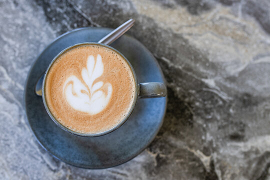 overhead view of a flat white coffee with latte art