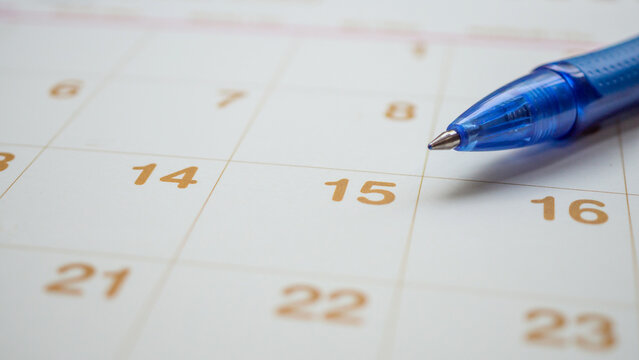 Blue pen on calendar page background business planning appointment meeting concept