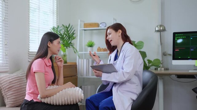 Psychologist counseling a depressed woman during a therapy session, discussing mental health and treatment in the office