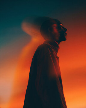 Abstract creative portrait of a man in profile with motion blur effect and vibrant warm gradient lighting