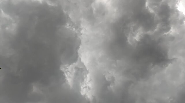 Dramatic dark storm clouds filling the sky before a heavy rainfall, creating a moody and atmospheric weather background