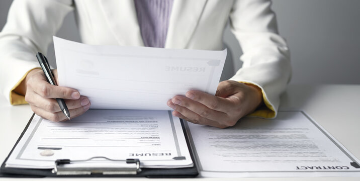 Businesswoman Reviewing Resumes for Recruitment and Hiring Candidates, Analyzing Applicant Information Before Job Interviews in Human Resources and Corporate Office