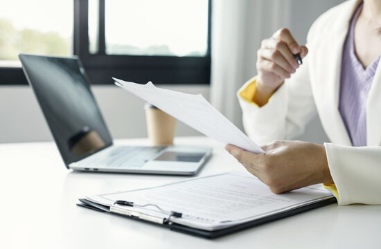 Businesswoman Reviewing Resumes for Recruitment and Hiring Candidates, Analyzing Applicant Information Before Job Interviews in Human Resources and Corporate Office