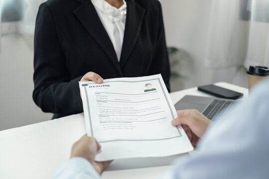 Business people hold a resume and talk to job applicants for job interviews about careers and Their personal history in the company. Recruitment concepts