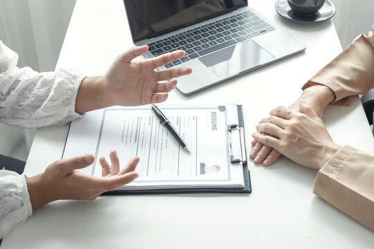 Business people hold a resume and talk to job applicants for job interviews about careers and Their personal history in the company. Recruitment concepts