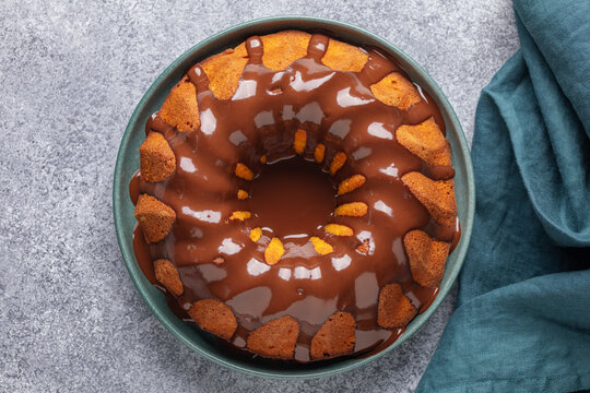 Brazilian carrot cake, bolo de cenoura, with chocolate glaze on the plate. Dessert, baked, delicious. Top view