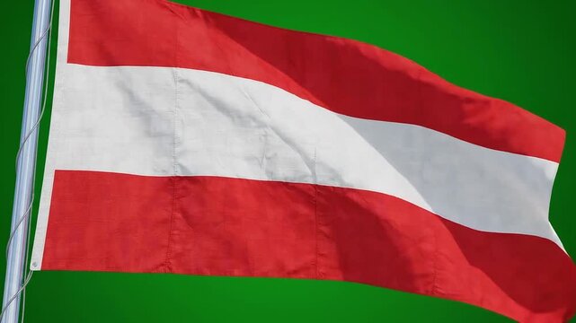 National flag of austria waving proudly against a green background