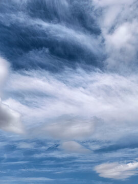 Abstract Cloud Patterns in Blue Summer Sky