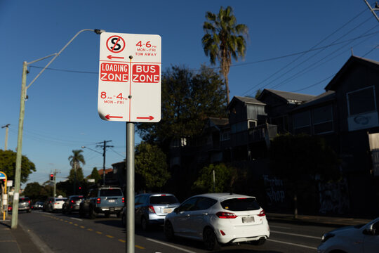 parking rules traffic sign on an inner Brisbane street with traffic in the background