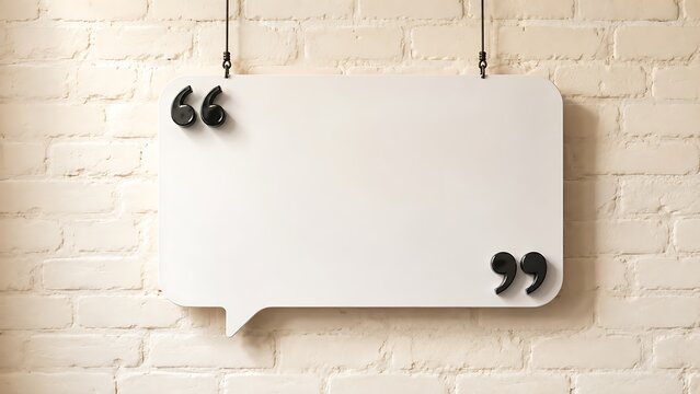 White hanging speech bubble plate with quotation marks on beige brick wall background for testimonial quotes.
