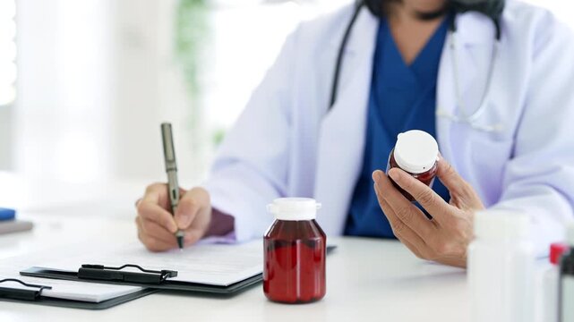 Physician prescribing pills and supplements to patient