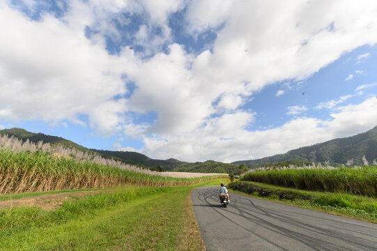 Young couple riding a scooter exploring far north Queensland