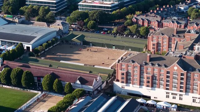 Drone pull-back from horses riding at RDS Grounds revealing Dublin city buildings, Ireland