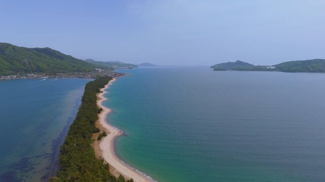 Aerial view of Amanohashidate sandbar between turquoise waters in Kyoto, Japan
