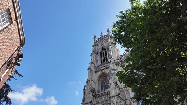 York Minster Cathedral Tower Rising Above Historic Streets in York England North Yorkshire