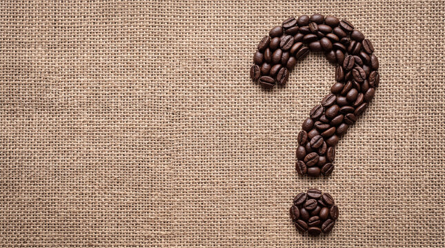 Question mark symbol made of roasted coffee beans on a rustic burlap sack background.