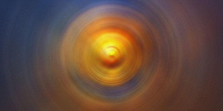 Abstract orange and yellow radial blur background with glowing center for modern art and designs.
