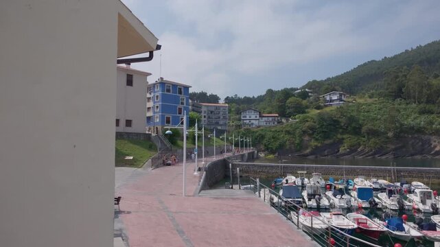 Armintza fishing port in the Basque Country, Spain, with numerous small boats moored, reflecting the coastal lifestyle and maritime economy