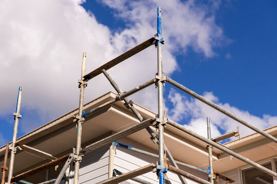 scaffolding and some of the roof line of a house under construction