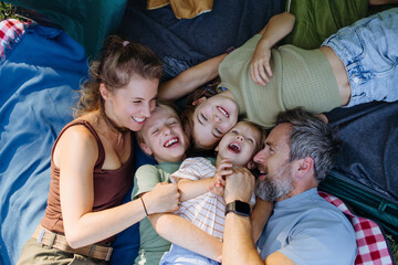 Naklejka premium Happy family spending time together during summer camping trip.