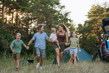 Naklejka premium Happy family spending time together during summer camping trip.