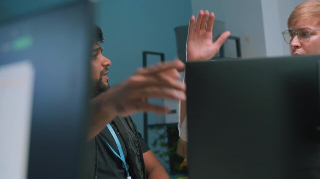 Two software development teams collaborated to discuss AI coding and project strategies at work, brainstorming and congratulating each other on successes