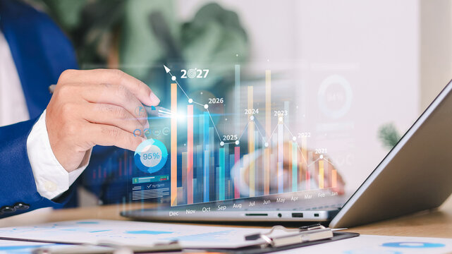 Business analyst using a laptop dashboard with digital charts, growth metrics, and market trends, representing financial planning, data analysis,