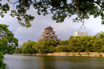 Ancient castle rises above lush green trees © Sando