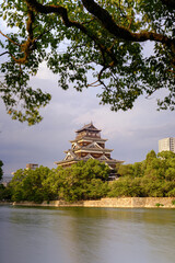 Ancient castle rises above lush green trees © Sando