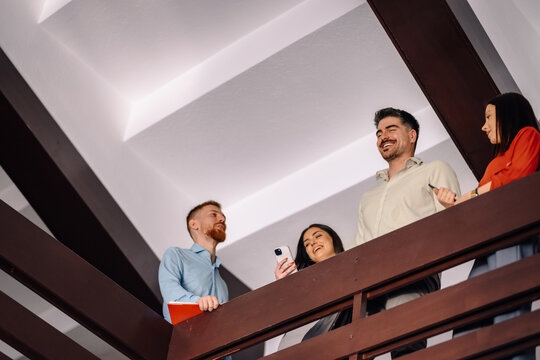 Business colleagues having animated discussion on office staircase