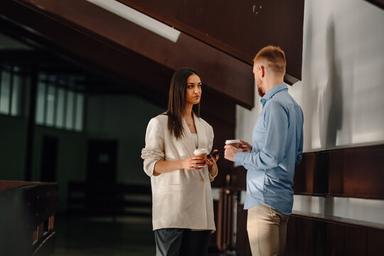 Business colleagues having coffee break and office discussion