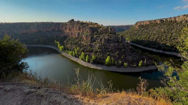 Hoces del Duraton river meander canyon view, Segovia Spain. Wide panorama of horseshoe bend, limestone cliffs and blue sky. High quality 4k footage