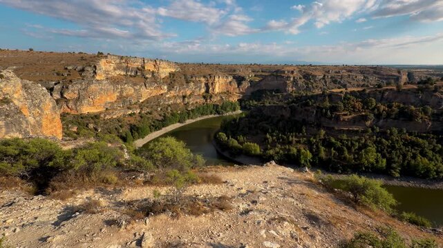 Hoces del Duraton river meander canyon view, Segovia Spain. Wide panorama of horseshoe bend, limestone cliffs and blue sky. High quality 4k footage