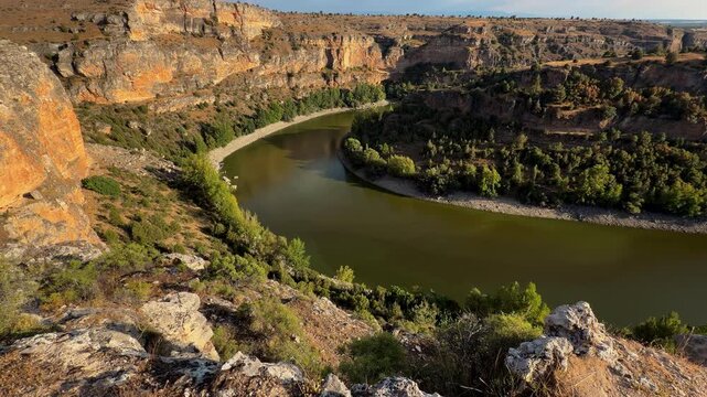 Hoces del Duraton river meander canyon view, Segovia Spain. Wide panorama of horseshoe bend, limestone cliffs and blue sky. High quality 4k footage