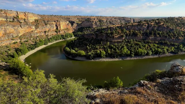 Hoces del Duraton river meander canyon view, Segovia Spain. Wide panorama of horseshoe bend, limestone cliffs and blue sky. High quality 4k footage
