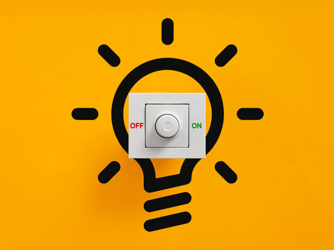 Dimmer switch activating a light bulb idea concept