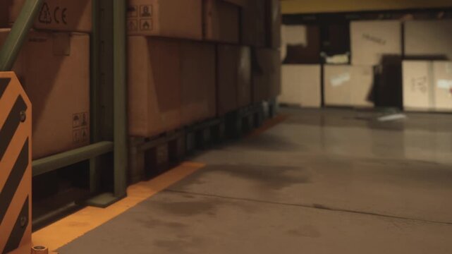 A storage area shows a wet floor, with yellow and black caution sign present. Cardboard boxes are placed on shelves in the background. The scene indicates a recent spill.