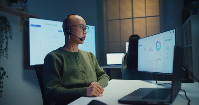 Team young Asian businesswoman working late talk on telephone headset in call center office at night. Corporate customer service support, telemarketing, finance insurance investment advisor concept.