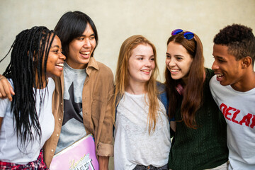 Diverse friends smiling together outdoors.