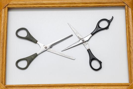 Two scissors are in a frame
