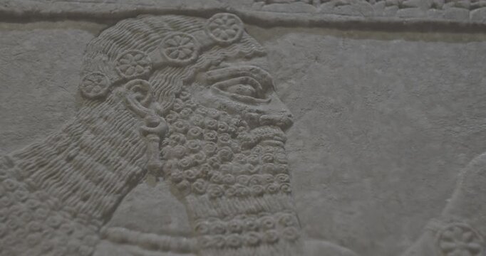 Close-up view on Winged Figure. Ungraded C LOG 2 Architectural Fragment Of Panel From Northwest Palace Of Ashurnasirpal Ii By Neo Assyrian Period. Depicted Is Winged Human Divine Spirit, Protective