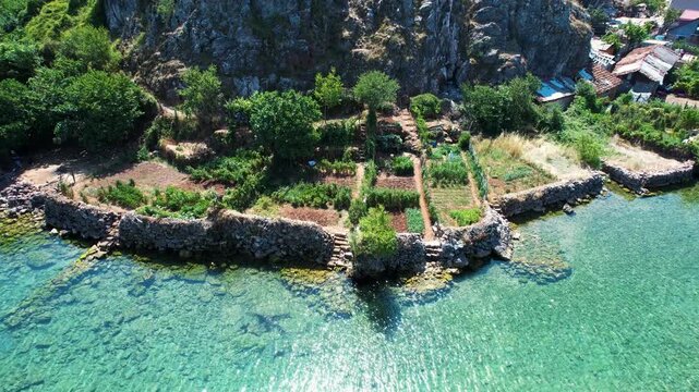 Tourists enjoy delicious fresh lake fish food in quiet Lin village peninsula on Ohrid lake