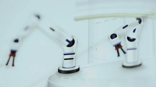 White robotic arms populate clean automated factory